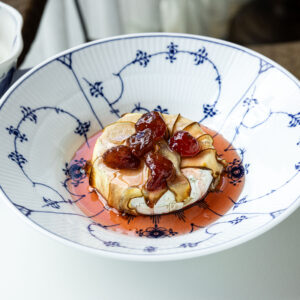 Baked Brie cheese with pear and wild strawberry jam